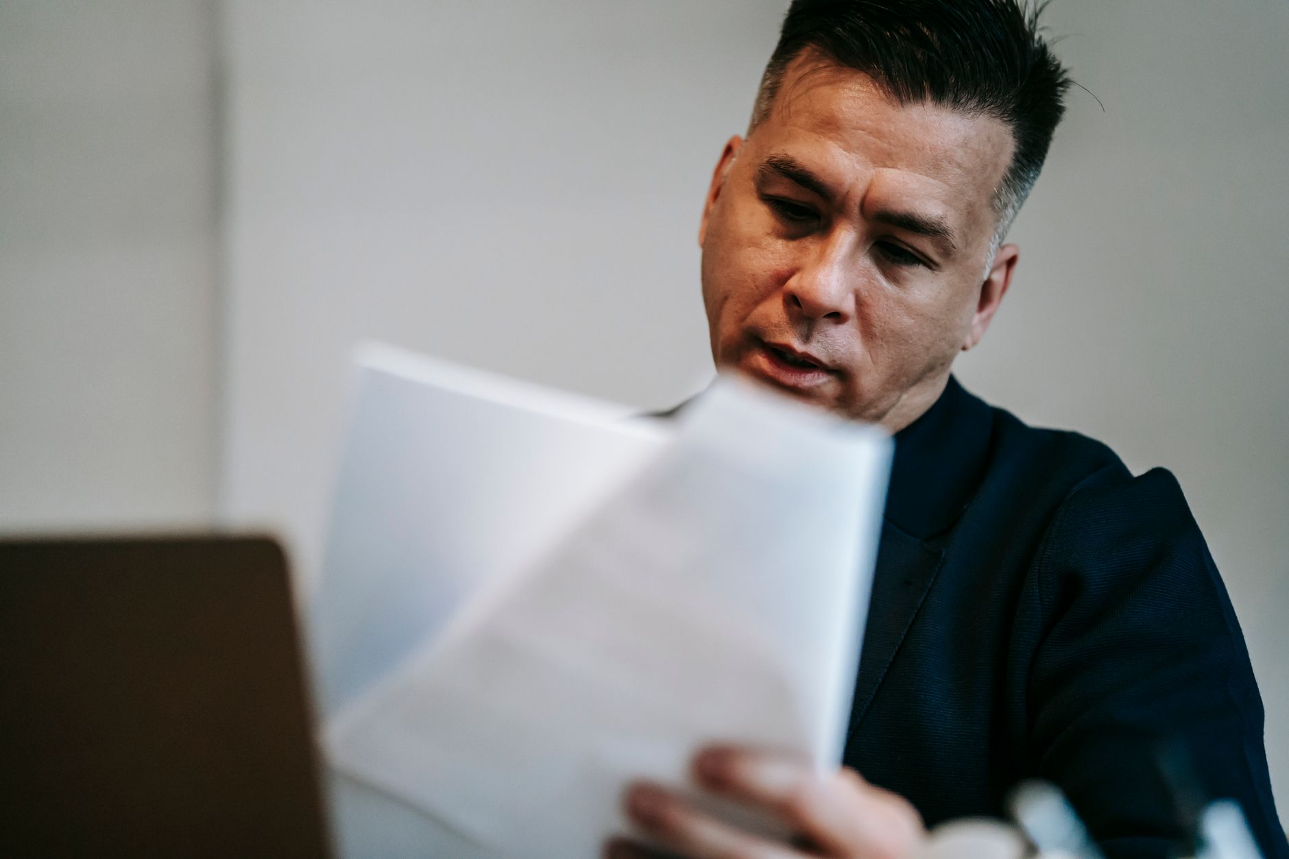 Defense contractor reviewing controlled documents at a workstation